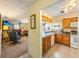 Kitchen with wood cabinets, stainless steel appliances, and breakfast bar at 3511 Camino Real, Sarasota, FL 34239