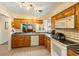 Bright kitchen with wood cabinets, appliances, and a breakfast bar at 3511 Camino Real, Sarasota, FL 34239