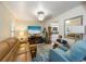 Cozy living room with light teal accent chair and large TV at 3511 Camino Real, Sarasota, FL 34239