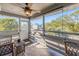 Relaxing screened porch with wooden floor and outdoor seating at 3511 Camino Real, Sarasota, FL 34239