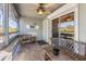 Relaxing screened porch with wooden furniture at 3511 Camino Real, Sarasota, FL 34239