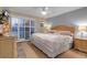King-size bedroom with sliding doors to balcony and wicker furniture at 4119 61St Avenue W Ter # 105, Bradenton, FL 34210