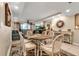 Open concept dining area with seating for six and views into the living room at 4119 61St Avenue W Ter # 105, Bradenton, FL 34210