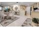 Open concept dining room flowing into the kitchen and living area with tiled floor and light neutral walls at 4119 61St Avenue W Ter # 105, Bradenton, FL 34210