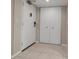 Clean and bright entryway with tile flooring, a white door, and double closet doors at 4119 61St Avenue W Ter # 105, Bradenton, FL 34210