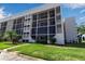 Modern condo building featuring floor-to-ceiling screened windows and well maintained landscaping and green space at 4119 61St Avenue W Ter # 105, Bradenton, FL 34210