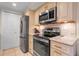 Modern kitchen with updated cabinetry, stainless steel appliances, and granite countertops at 4119 61St Avenue W Ter # 105, Bradenton, FL 34210