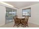 Bright dining area with wood table and chairs, and view to backyard at 4132 Deerfield Dr, Sarasota, FL 34233