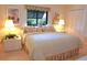 Inviting bedroom with floral accents, soft lighting, and a large window at 4234 Gulf Of Mexico Dr # Y2, Longboat Key, FL 34228