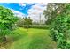 Landscaped backyard with lush green grass at 4477 Sandner Dr, Sarasota, FL 34243