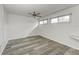 Bright bedroom with wood-look floors and ceiling fan at 4477 Sandner Dr, Sarasota, FL 34243
