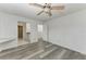 Bedroom with wood-look floors, ceiling fan and built-in shelving at 4477 Sandner Dr, Sarasota, FL 34243