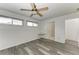Spacious bedroom with wood-look floors, ceiling fan and access to bathroom at 4477 Sandner Dr, Sarasota, FL 34243
