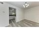 Dining room with kitchen view and wood-look floors at 4477 Sandner Dr, Sarasota, FL 34243