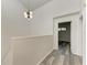 Upper level hallway with wood-look floors and access to bedroom at 4477 Sandner Dr, Sarasota, FL 34243