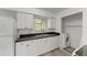 Well-equipped kitchen with white cabinets and black countertops at 4477 Sandner Dr, Sarasota, FL 34243