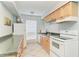 Efficient galley kitchen, features white appliances and ample counter space at 4477 Sandner Dr, Sarasota, FL 34243