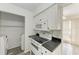 Modern kitchen with white cabinets, black countertops and appliances at 4477 Sandner Dr, Sarasota, FL 34243