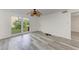 Bright living room with large windows and wood-look floors at 4477 Sandner Dr, Sarasota, FL 34243