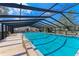 Community pool area, screened and includes lounge chairs at 4477 Sandner Dr, Sarasota, FL 34243