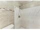 Updated shower with marble and neutral tile at 4477 Sandner Dr, Sarasota, FL 34243