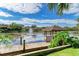 Quaint gazebo by the lake with a wooden dock and lush vegetation at 4507 Park Lake N Ter # 4507, Bradenton, FL 34209