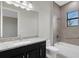 Bathroom with granite countertop, dark vanity, shower/tub combo at 4672 Mondrian Ct, Sarasota, FL 34240