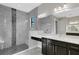 Elegant bathroom with marble shower, dark vanity, and modern fixtures at 4672 Mondrian Ct, Sarasota, FL 34240