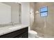 Bathroom with granite countertop, dark vanity, and walk-in shower at 4672 Mondrian Ct, Sarasota, FL 34240