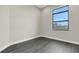 Bedroom with grey wood-look flooring and a large window at 4672 Mondrian Ct, Sarasota, FL 34240