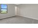 Well-lit bedroom with gray carpeting and a window offering a view at 4672 Mondrian Ct, Sarasota, FL 34240