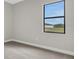 Spacious bedroom with grey carpet and large window offering natural light at 4672 Mondrian Ct, Sarasota, FL 34240
