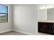 Well-lit bedroom with grey carpet and ensuite bathroom access at 4672 Mondrian Ct, Sarasota, FL 34240