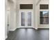 Bright entryway with double doors and dark hardwood floors at 4672 Mondrian Ct, Sarasota, FL 34240