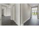 Clean and bright hallway with dark gray vinyl flooring and neutral walls at 4672 Mondrian Ct, Sarasota, FL 34240