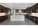 Eat-in kitchen with island, stainless steel appliances, and dark wood cabinetry at 4672 Mondrian Ct, Sarasota, FL 34240