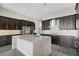 Spacious kitchen boasts dark cabinetry, expansive island, and stainless steel appliances at 4672 Mondrian Ct, Sarasota, FL 34240