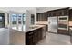 Island kitchen features stainless steel appliances and expansive granite countertops at 4672 Mondrian Ct, Sarasota, FL 34240