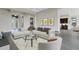 Open living room with sectional sofa and view into kitchen at 4672 Mondrian Ct, Sarasota, FL 34240