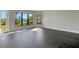 Spacious living room featuring large windows, and dark gray vinyl flooring at 4672 Mondrian Ct, Sarasota, FL 34240