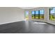 Bright and airy living room with dark gray vinyl flooring and access to the outdoors at 4672 Mondrian Ct, Sarasota, FL 34240