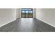 Sunlit living room showcasing wood-look flooring and sliding glass doors at 4672 Mondrian Ct, Sarasota, FL 34240