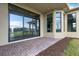 Covered patio with paver stones and sliding glass doors at 4672 Mondrian Ct, Sarasota, FL 34240