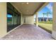 Covered patio with paver stones and access to backyard at 4672 Mondrian Ct, Sarasota, FL 34240
