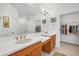Bathroom featuring a double vanity, large mirror, walk-in shower and walk-in closet at 4705 Tortona Ct, Bradenton, FL 34211