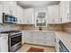 Modern kitchen with stainless steel appliances, gas range, and decorative tile backsplash at 4705 Tortona Ct, Bradenton, FL 34211