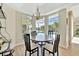 Casual dining area with round table and chairs, overlooking the pool at 4724 White Tail Ln, Sarasota, FL 34238