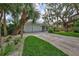 Front view of a white house with a two-car garage and a well-maintained lawn at 5341 Siesta Ct, Sarasota, FL 34242