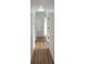 Long hallway with light wood-look floors and white walls at 6593 Kenwood Dr, North Port, FL 34287