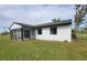 White house exterior with black accents and a screened-in patio at 6593 Kenwood Dr, North Port, FL 34287